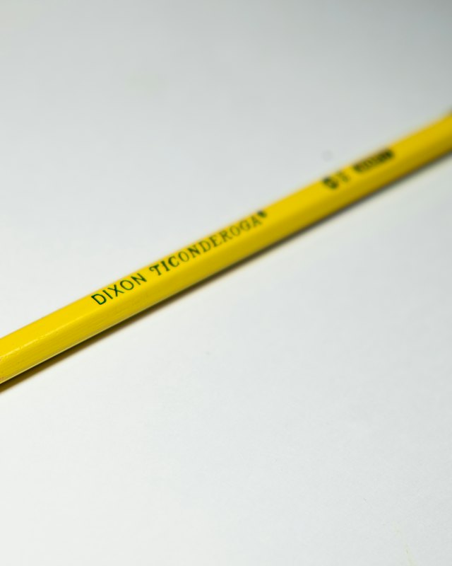 A yellow pencil on a white background