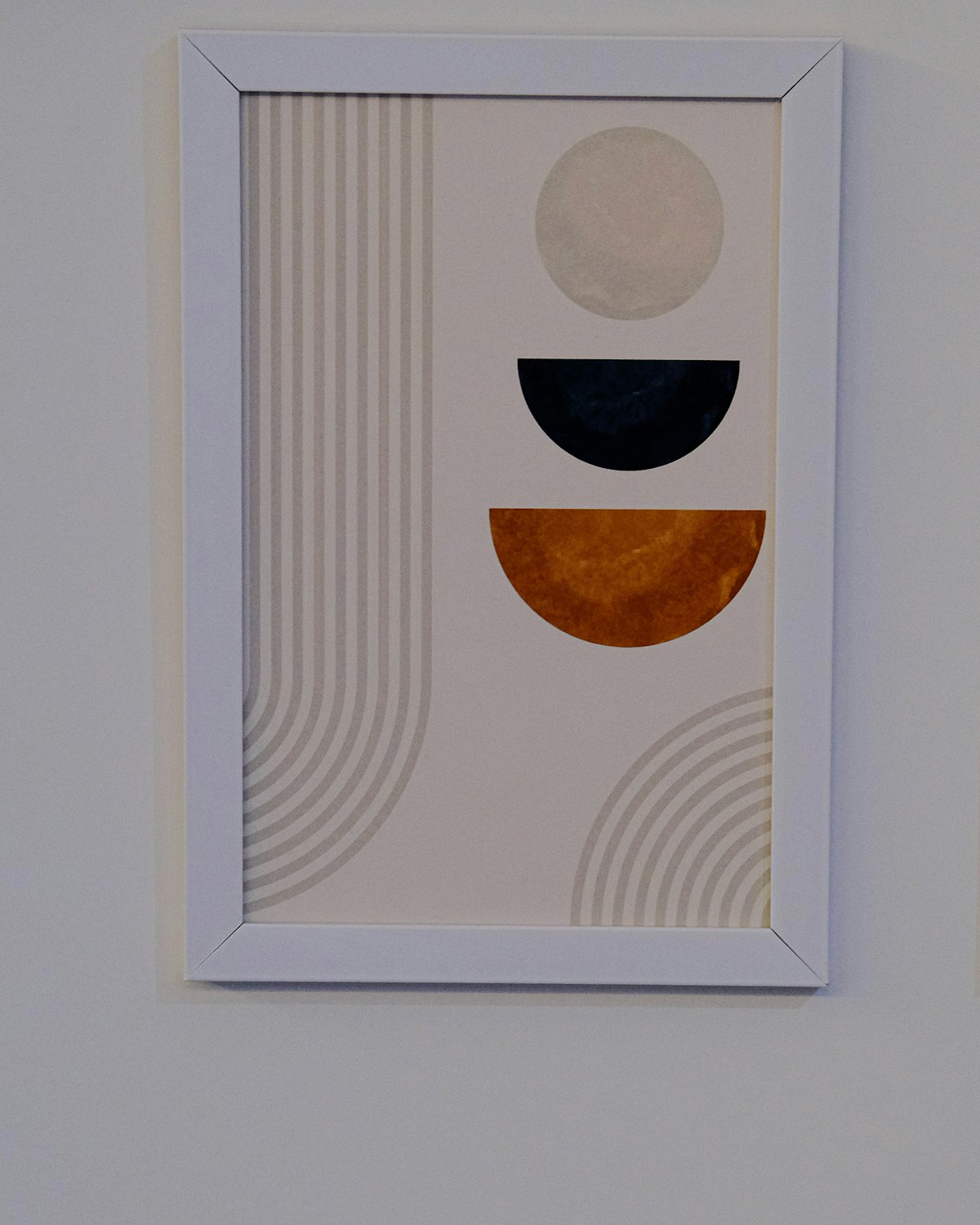 An abstract print of simple shapes in a white frame